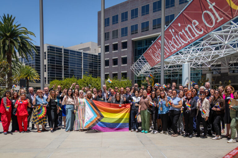 a group of people holding a pride flag