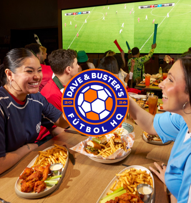a group of people around a table filled with appetizers at Dave & Buster's