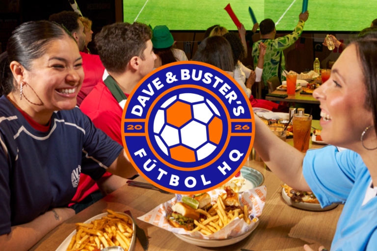 a group of people around a table filled with appetizers at Dave & Buster's