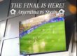 a tv on a wall showing a soccer game
