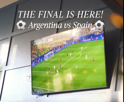 a tv on a wall showing a soccer game
