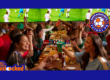 a group of people around a table celebrating a World Cup game at Dave & Buster's