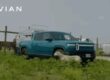 a sheep running past a Rivian truck