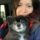 a woman with a cute, sugar-faced black dog on her lap