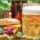 a burger sitting next to a glass of beer
