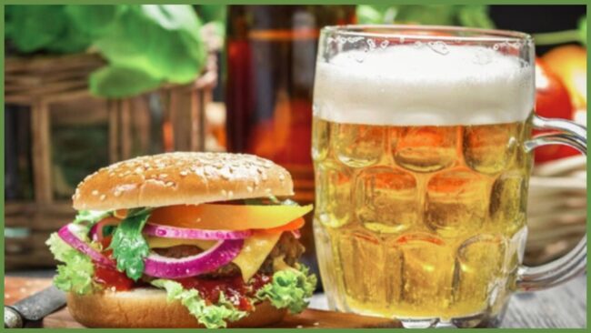 burgers and brews event at the Kensington a burger sitting next to a glass of beer