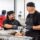 two men in a food kitchen preparing food